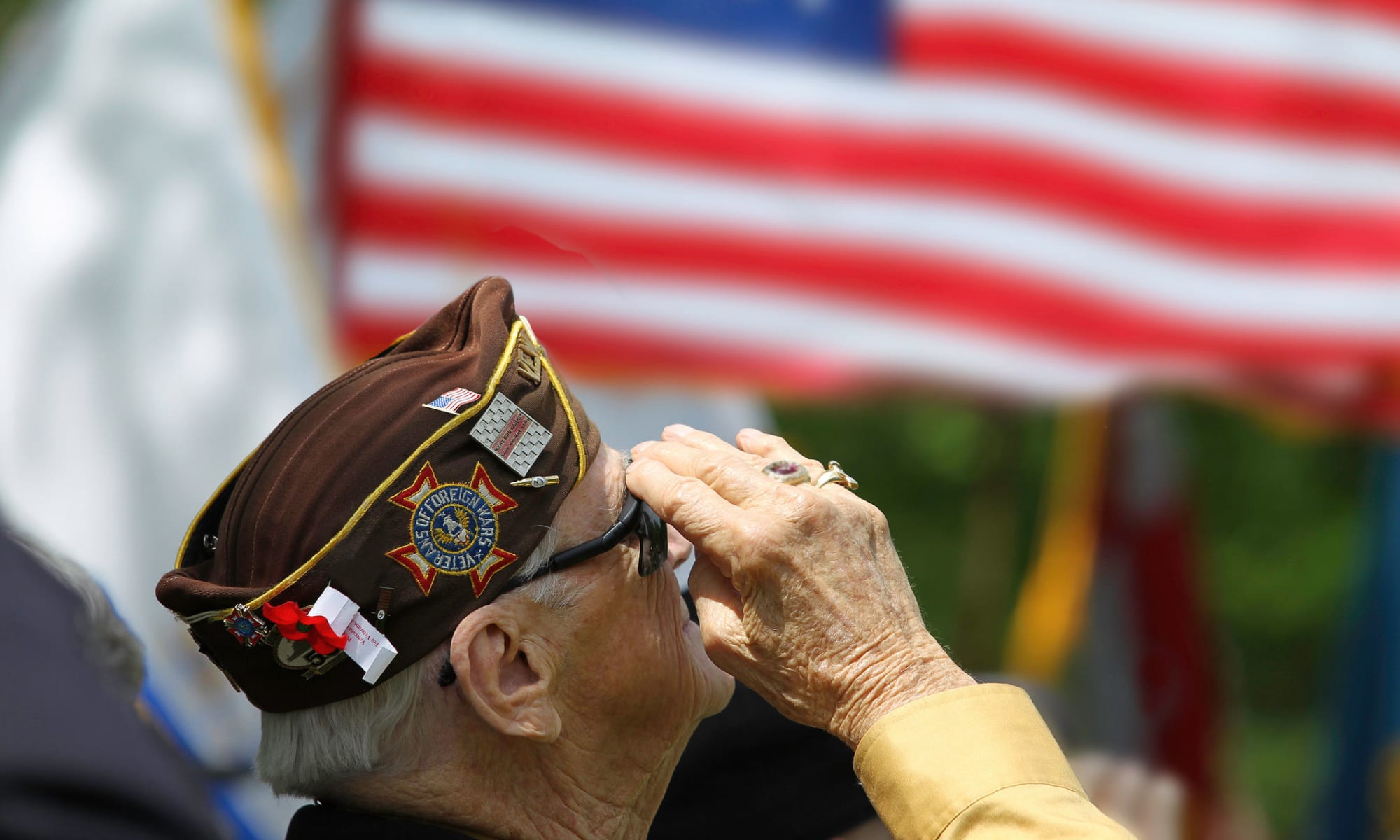 A veteran salutes the flag at Wildcat Senior Living in Summerville, South Carolina