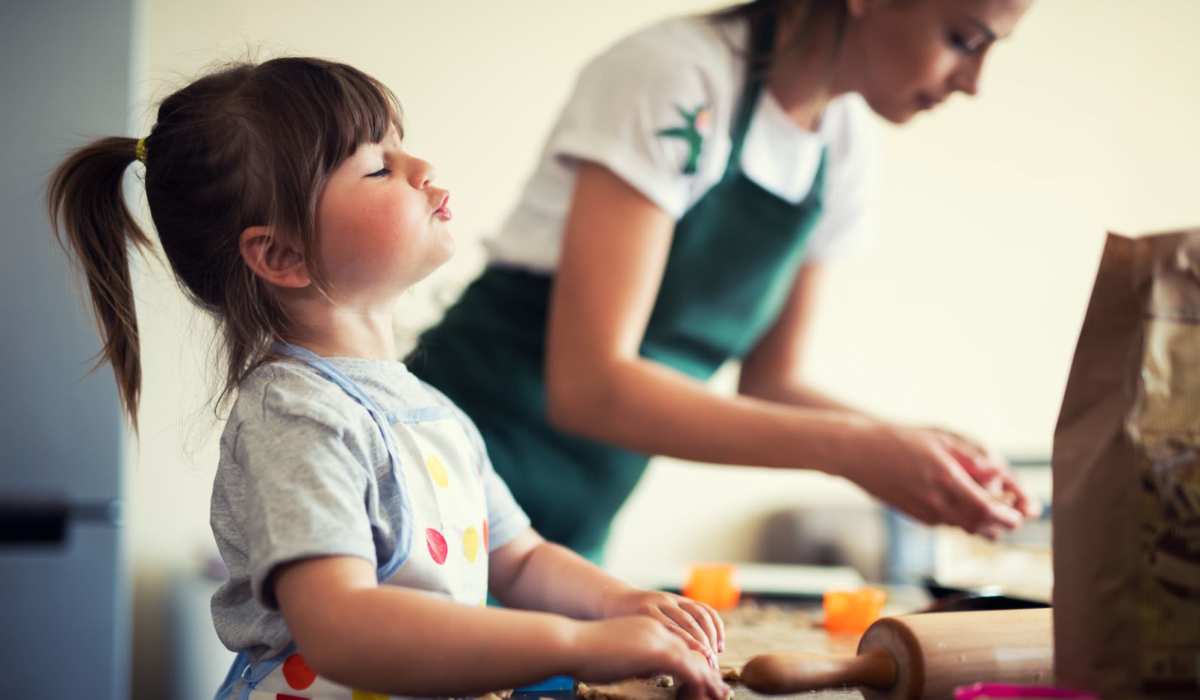 A mother and daughter bake cookies in their kitchen at Commons on Potomac Square, Sterling, Virginia