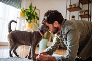 Resident playing with his pet cat at The Gardens At Pryor Creek in Pryor, Oklahoma