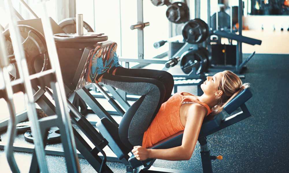 Resident doing leg workouts in the fitness center at Canton Overlook in Baltimore, Maryland