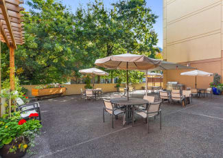 Beautiful back patio and gardens at Merrill Gardens at First Hill in Seattle, WA