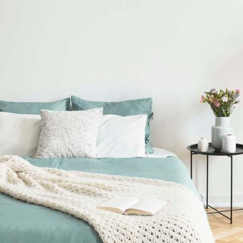 Bed with side table at Shea Ravines in Wyoming, Michigan