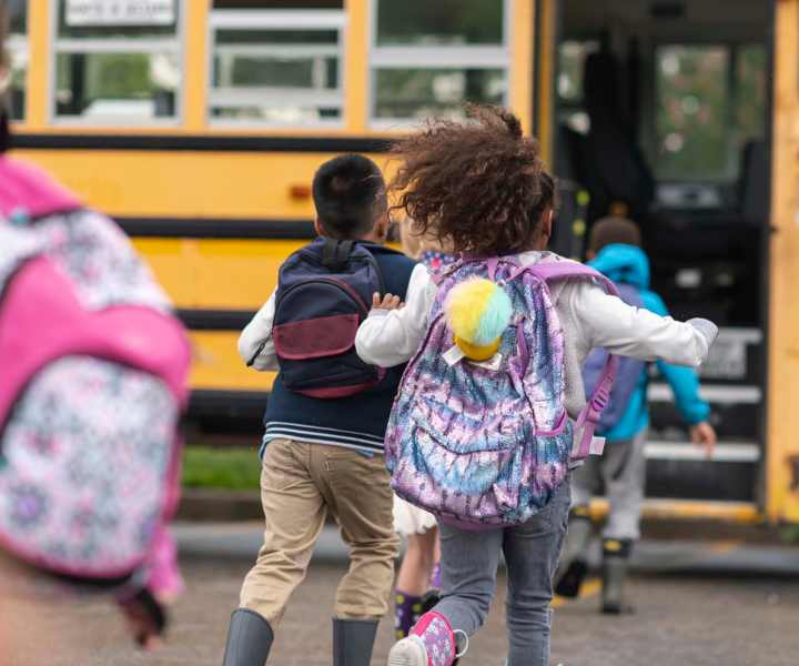 Children boarding school bus at Dunbar Apartments in Lexington, North Carolina
