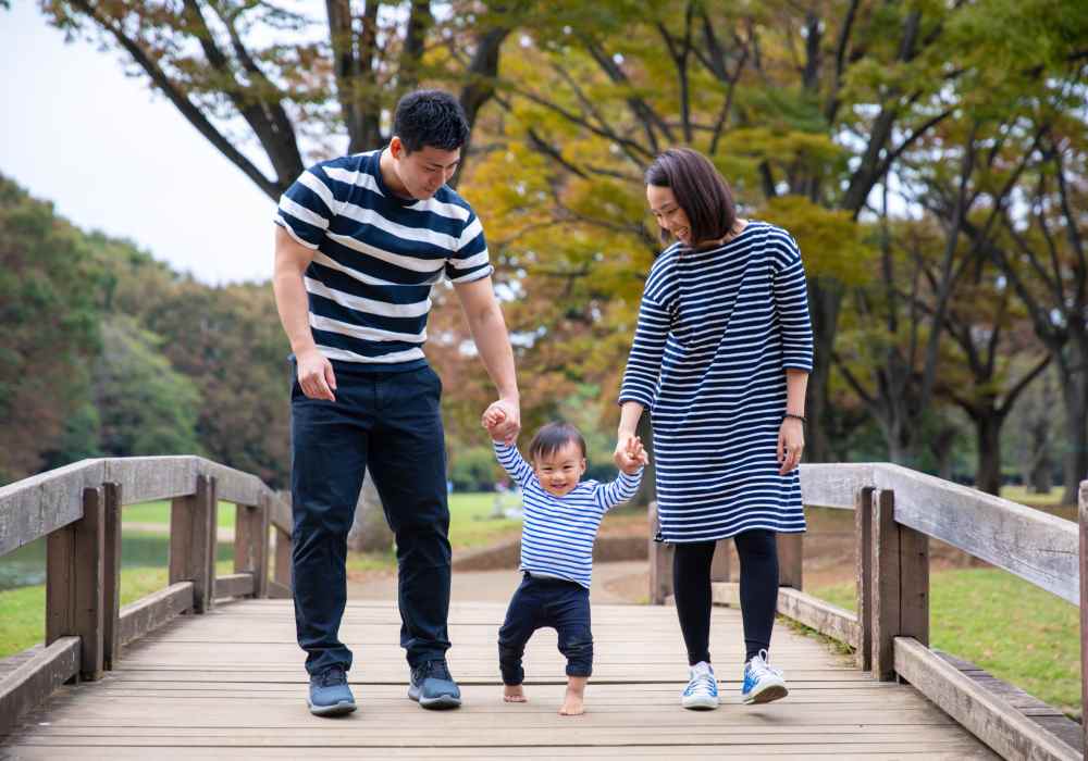 Resident couple with their kid in park near The Reserve at Kanapaha in Gainesville, Florida