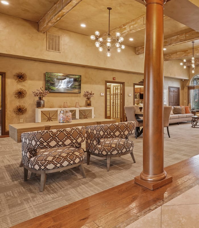 Communal sitting area with elegant chandeliers at Coffee Creek Apartments in Owasso, Oklahoma