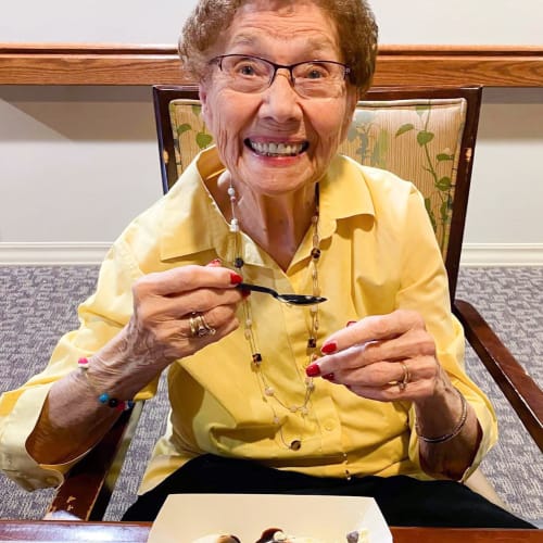 Resident eating ice cream The Oxford Grand Assisted Living & Memory Care in Wichita, Kansas