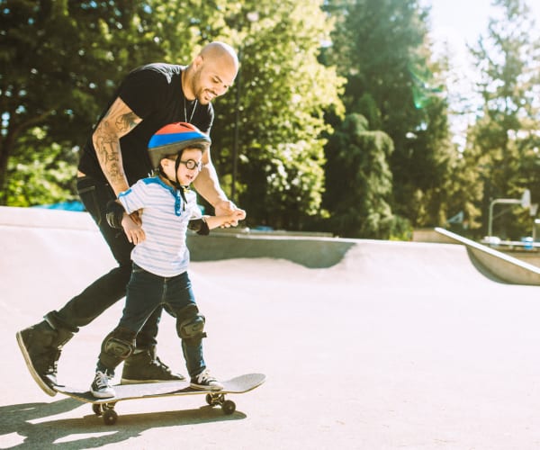 A father teaching his son how to skate near Capeharts West in San Diego, California