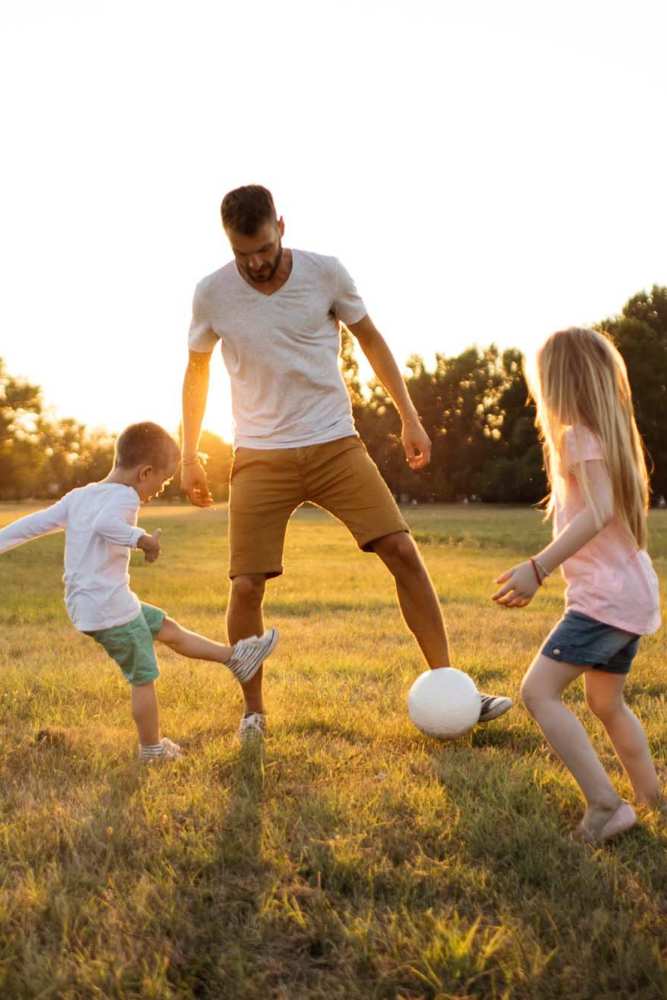 Resident playing with his children near Pine Lake Village in Houston, Texas