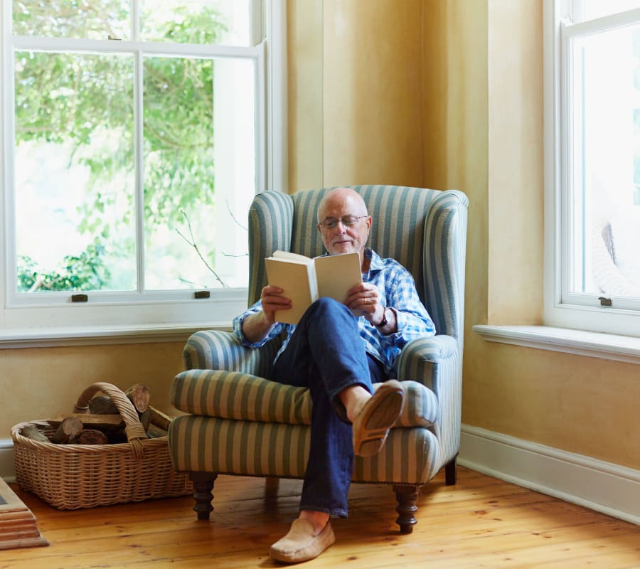 Man reading a book  at Cedarview Gracious Retirement Living in Woodstock, Ontario