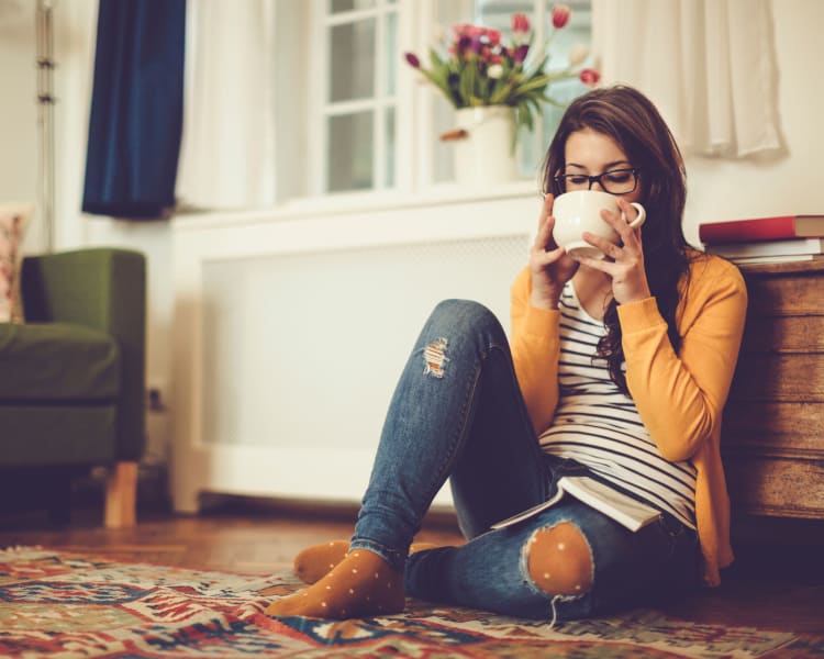 Resident relaxing with a cup of tea in her new home at Haven Martinez in Martinez, California