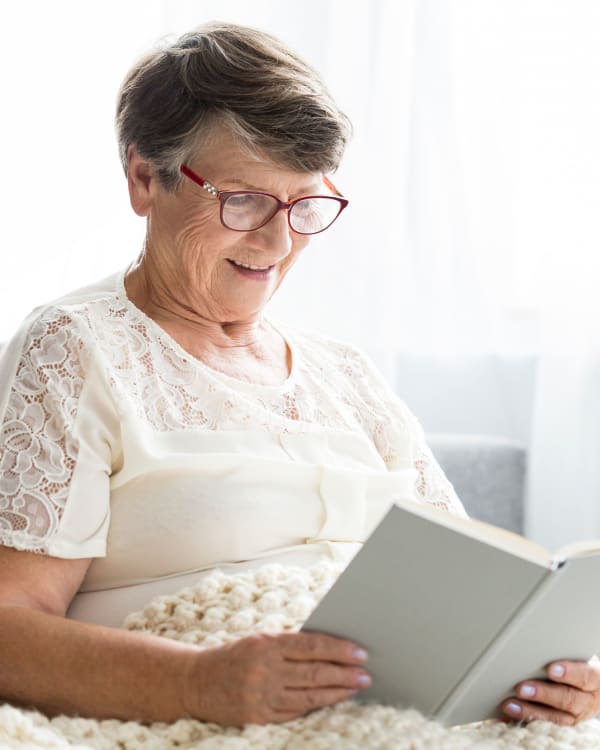 A woman reading a book at Trilogy Health Services in Louisville, Kentucky
