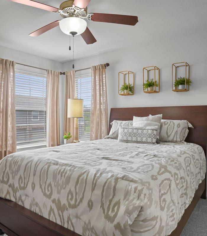 Chic bedroom with ceiling fan at Scissortail Crossing Apartments in Broken Arrow, Oklahoma