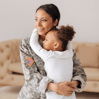 A mother hugging her daughter at Clarkdale in Joint Base Lewis McChord, Washington
