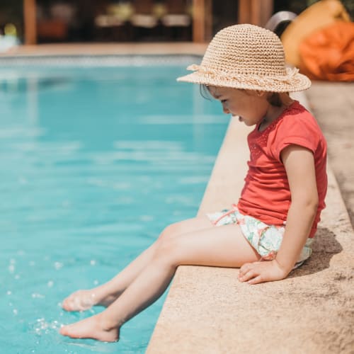 A resident child sitting at a swimming pool at San Onofre II in San Clemente, California