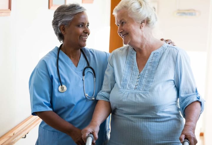 Caregiver with senior woman with walker