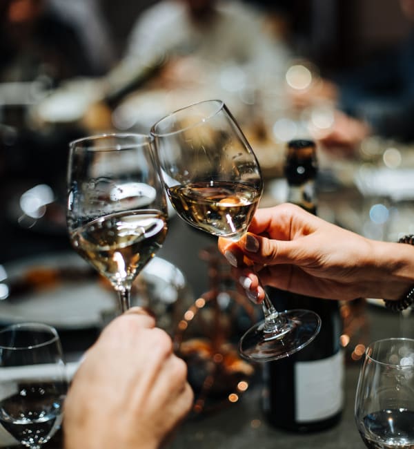 A group of people holding glasses of wine near Reagan Crossing in Covington, Louisiana