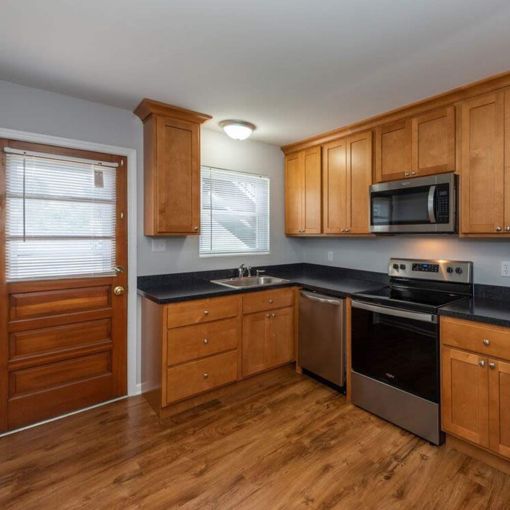 Apartment kitchen with wood flooring at Signal Hill Apartments in Mechanicsville, Virginia