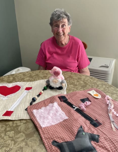 Barbara Richardson proudly displays two of her fidget quilts