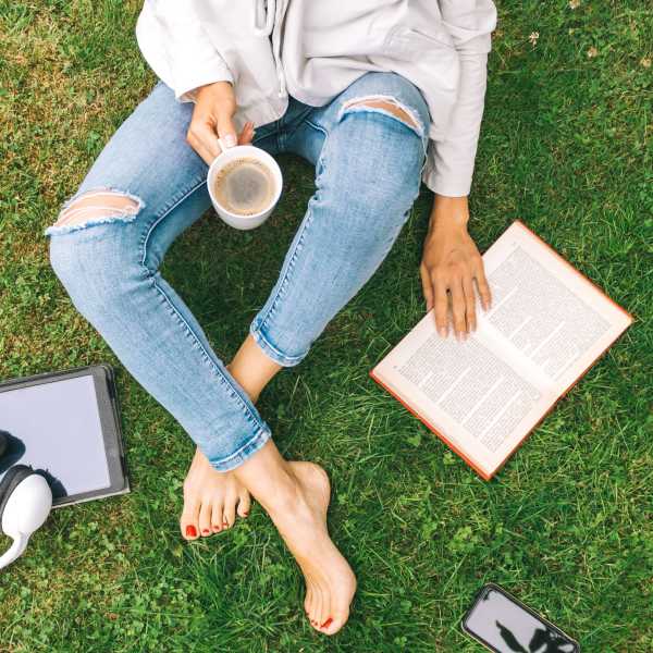 A resident reads a book on the lawn at Commons on Potomac Square, Sterling, Virginia