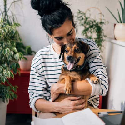 Resident holds her dog at Ironwood at Happy Valley in Phoenix, Arizona