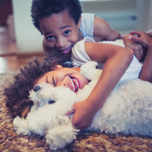 Children playing with a dog at Midway Manor in Virginia Beach, Virginia