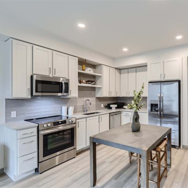 Modern kitchen with access to living room at Grand Peaks in Denver, Colorado