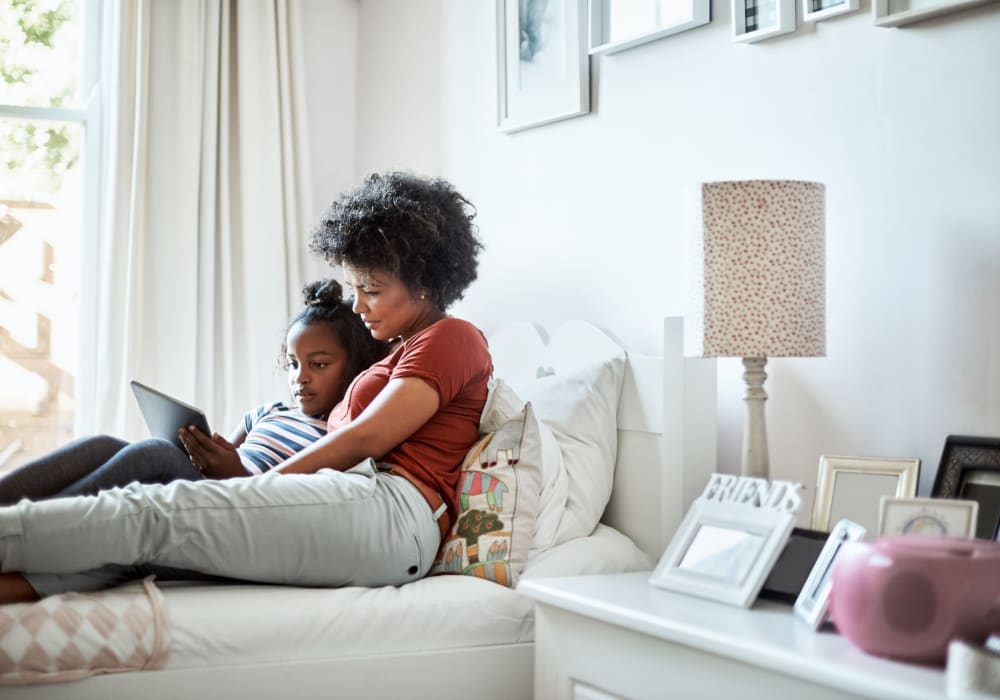 Mother and daughter reading in the bed at Dunbarton Apartments in Georgetown, Delaware