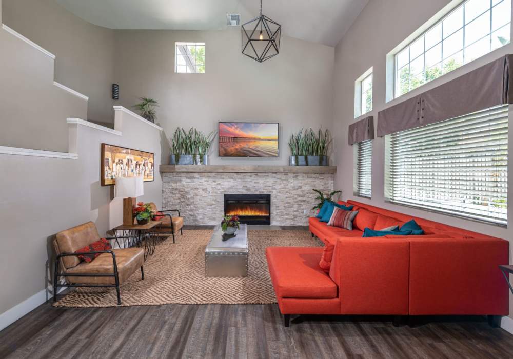 Spacious living room with red sofa and carpet at The Bluffs in Rancho Cucamonga, California