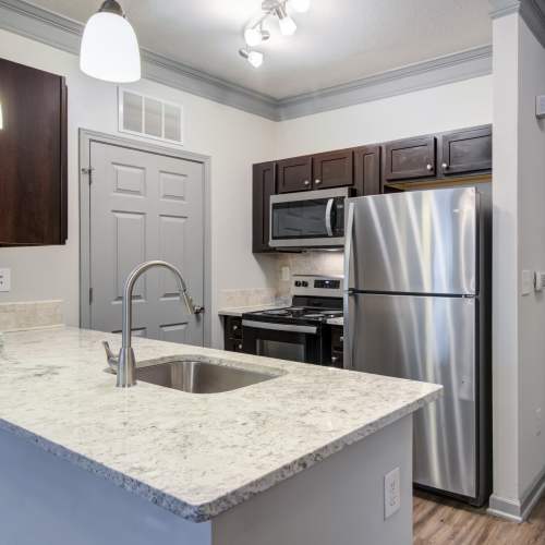 Galley style kitchen with designer finishes at Estates at McDonough Apartment Homes in McDonough, Georgia