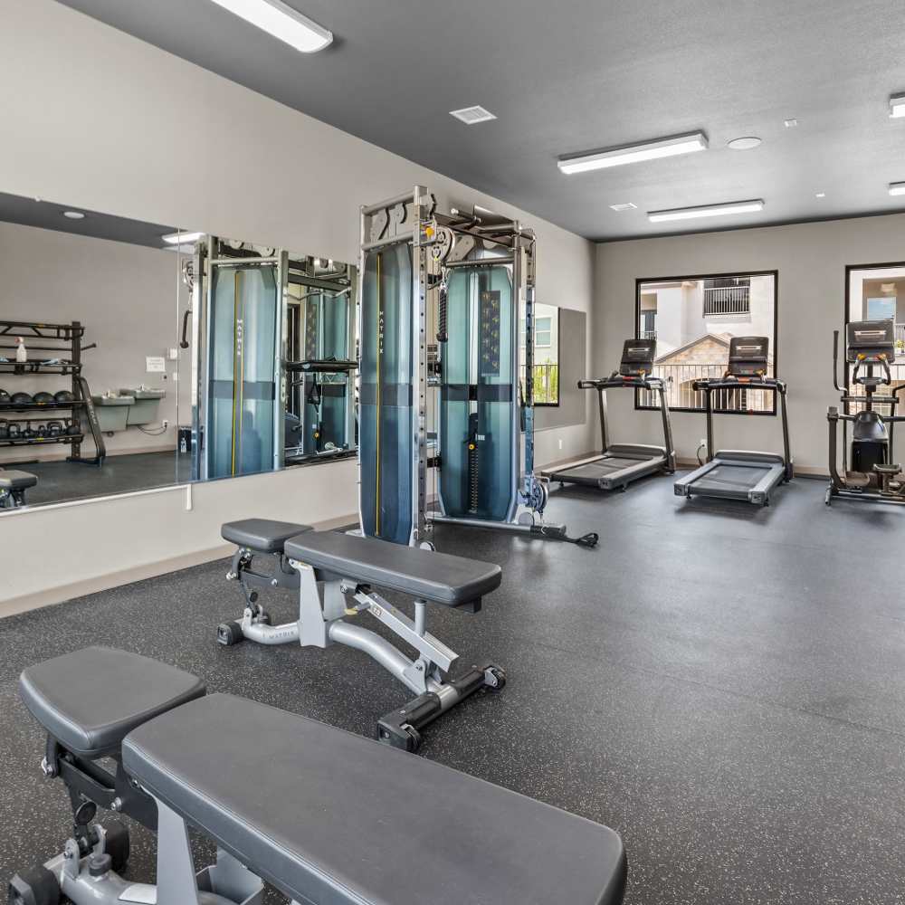 Fitness center with bench press at Retreat at Horizon Hills in El Paso, Texas