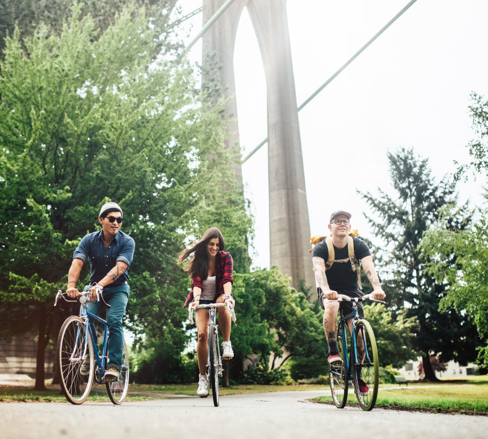 Three people riding bikes outdoors near Springwoods at Lake Ridge in Woodbridge, Virginia