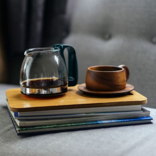 Coffee and a stack of books on a couch at Mosby Ingleside in North Charleston, South Carolina