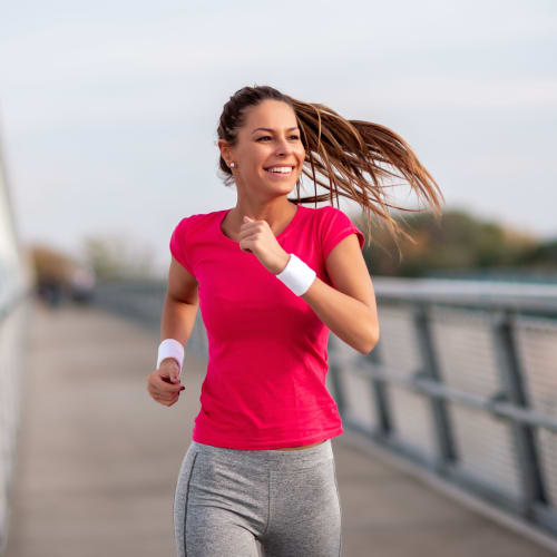 Woman jogging near Images Condominiums in Kissimmee, Florida