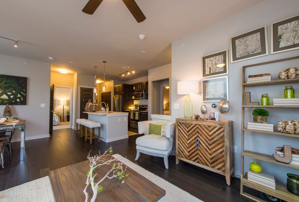 Open-concept floor plan with hardwood floors in the living area of model home at Elite 99 West in Katy, Texas
