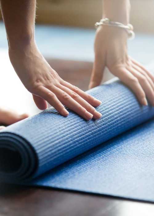 Resident rolling out her yoga mat at Proximity Watermark in Wilmington, North Carolina