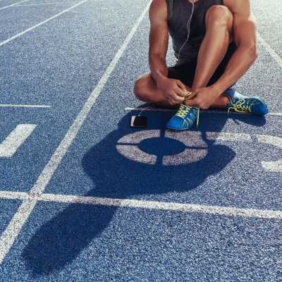 Resident lacing up his running shoes for a run on the track near Lofts at Square 45 in Allendale, Michigan