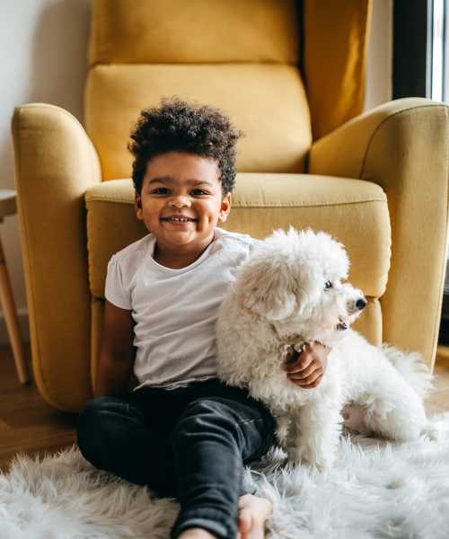 Bright room with child and dog on rug at Huron Square and The Osborn in Cleveland, Ohio