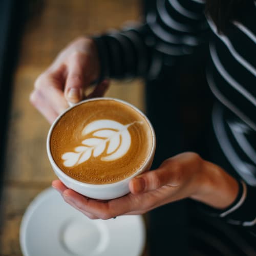 A resident holding a latte in a café near Madigan in Joint Base Lewis McChord, Washington