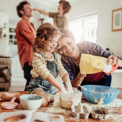 A family cooking in their kitchen at Seal Beach Officer Housing in Seal Beach, California