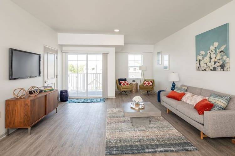 Spacious, well-lit living room at Winding Creek Apartments in Webster, New York