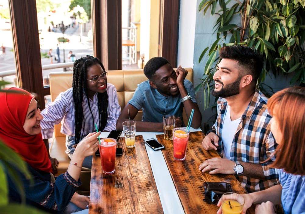 Resident friends out for drinks near Celsius Apartment Homes in Charlotte, North Carolina