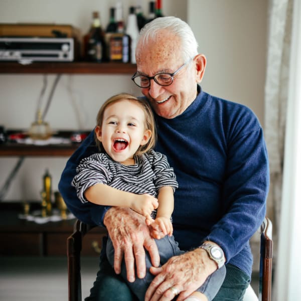 A resident holding his grandson at Pacifica Senior Living Bonita in Chula Vista, California. 