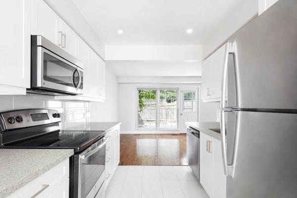 Modern kitchen with stainless steel appliances at Lion's Gate in Etobicoke
