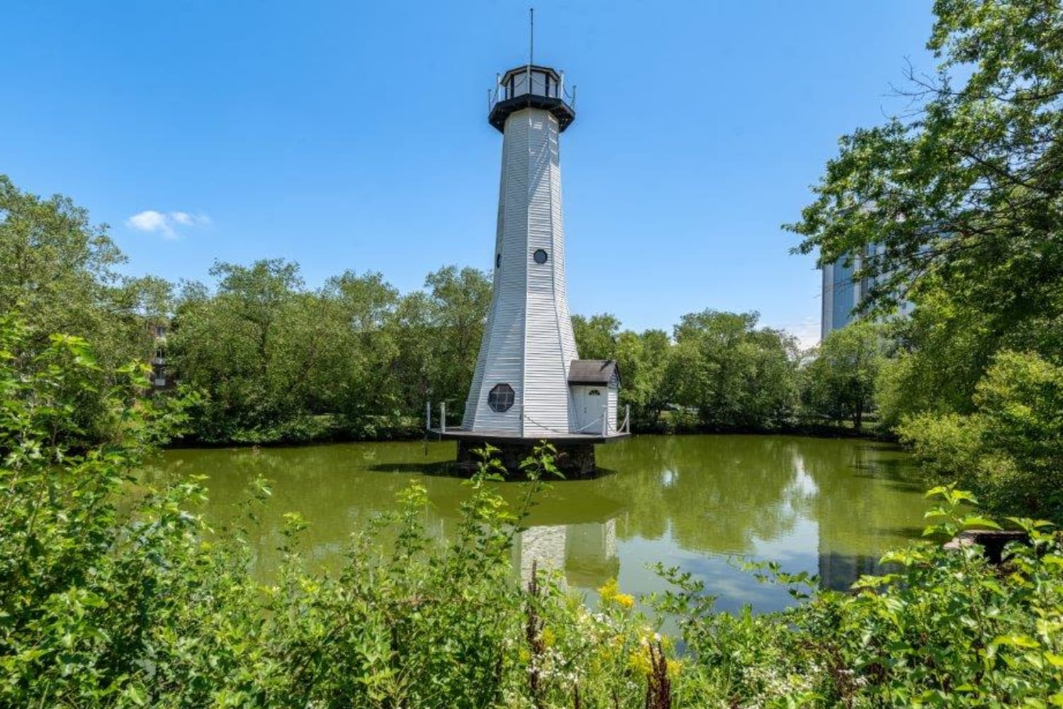 Lake with lighthouse at Lighthouse at Twin Lakes Apartment Homes in Beltsville, Maryland