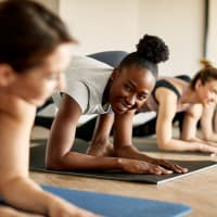 A group of women stretching in the fitness center at The Station at Brighton in Grovetown, Georgia