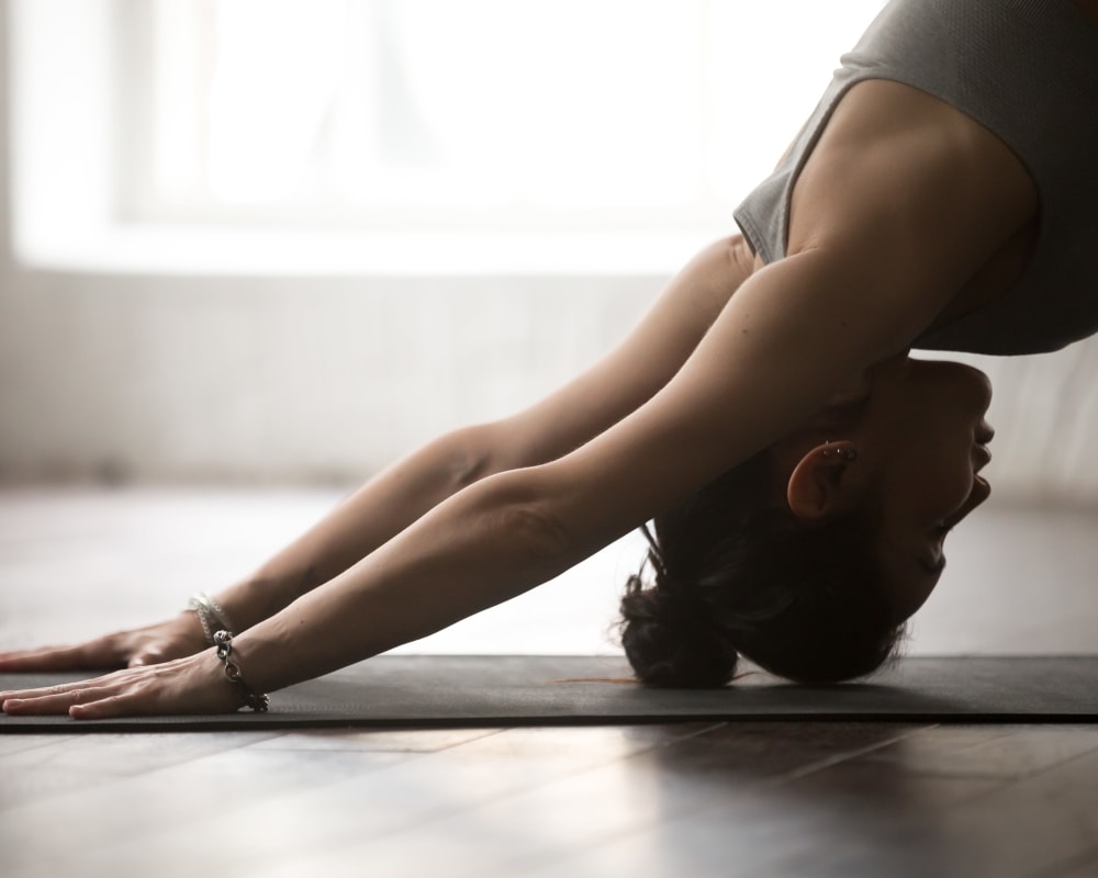 Resident doing yoga in their room at Oaks Trinity in Dallas, Texas