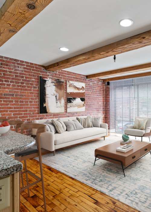 Model apartment living room with large windows at Cigar Lofts in Richmond, Virginia