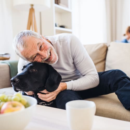 A resident holding his dog  at South Mesa I in Oceanside, California