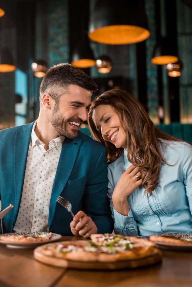 Resident couple having pizza near Pinyon Apartments in Reno, Nevada