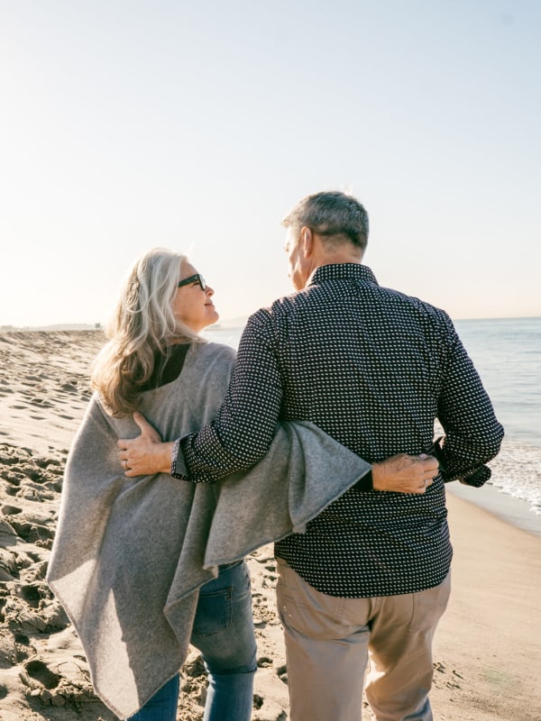 Couple taking a walk on the beach near Tuscany Pointe at Tampa Apartment Homes in Tampa, Florida